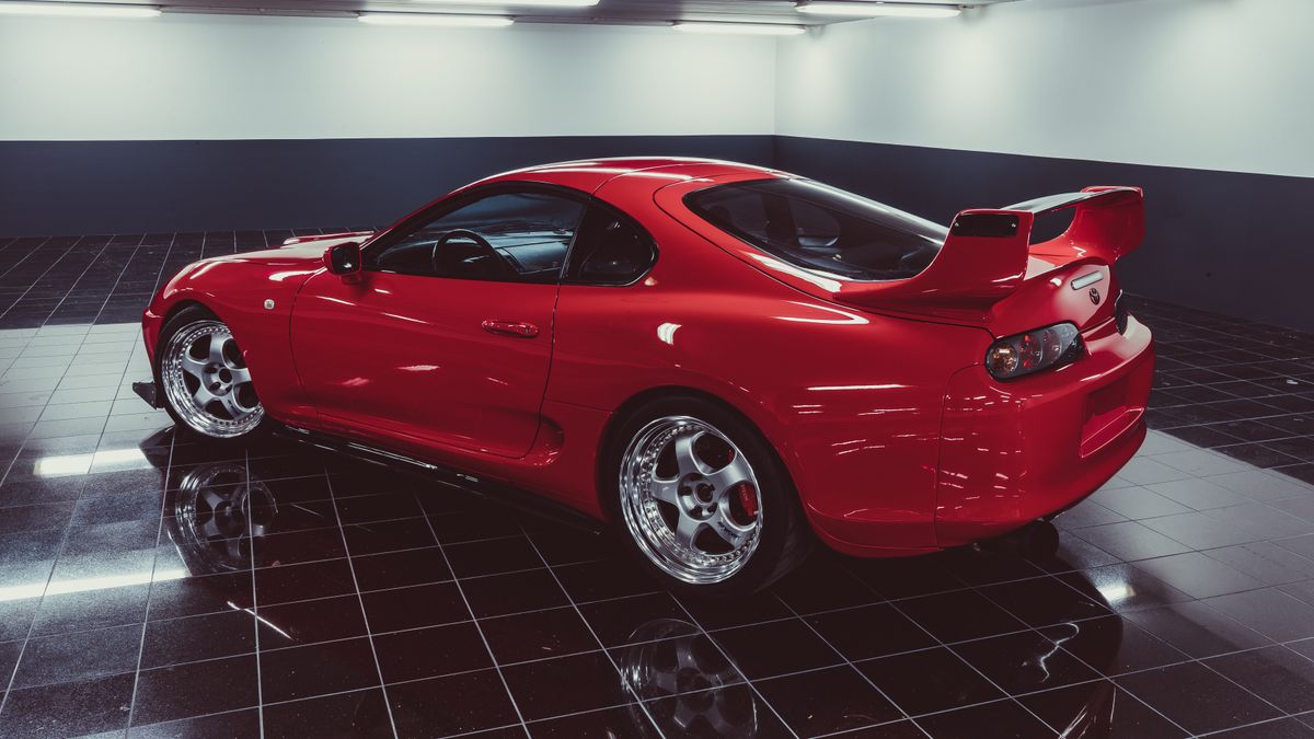 Sports car parked in a garage on a glossy floor